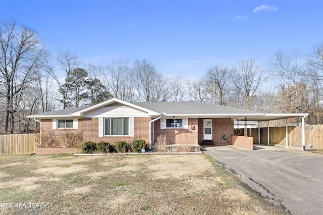 ranch-style house with a carport and a front lawn