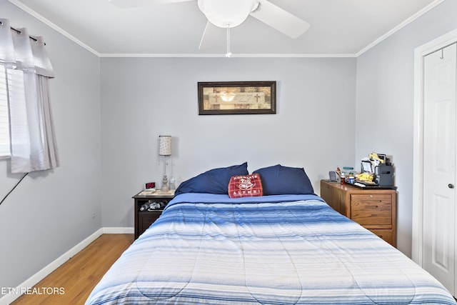 bedroom featuring hardwood / wood-style floors, ornamental molding, and ceiling fan