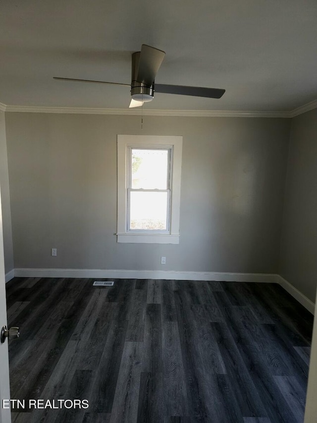 empty room featuring dark wood-type flooring, ornamental molding, and ceiling fan