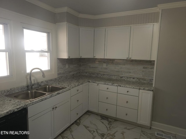 kitchen featuring black dishwasher, sink, white cabinets, backsplash, and light stone countertops