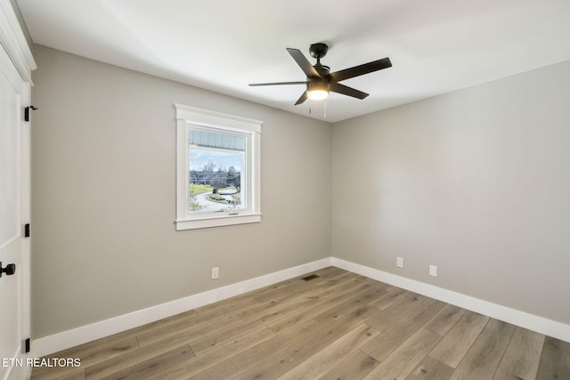 spare room with light hardwood / wood-style flooring and ceiling fan