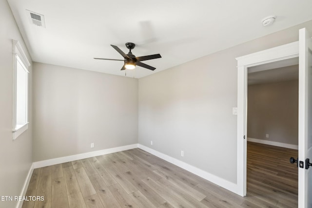 empty room with ceiling fan and light wood-type flooring