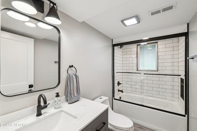 full bathroom with vanity, combined bath / shower with glass door, and toilet