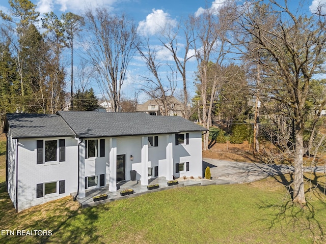 back of house with a yard