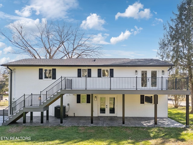 back of house with a lawn, a deck, central AC, a patio area, and french doors