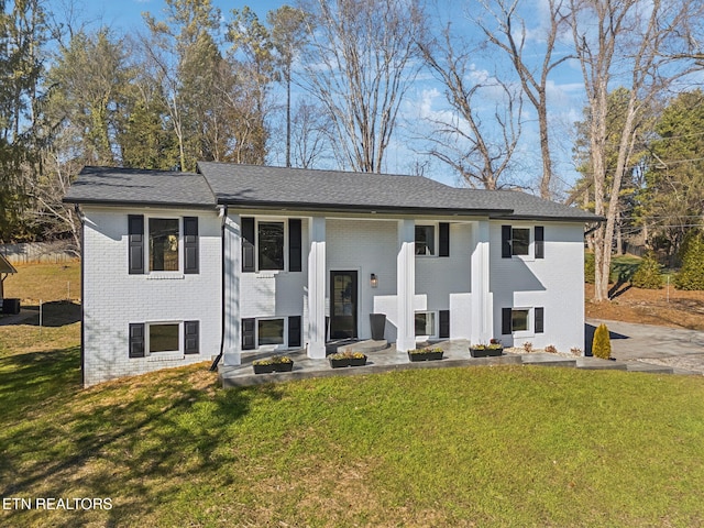 split foyer home with a front lawn