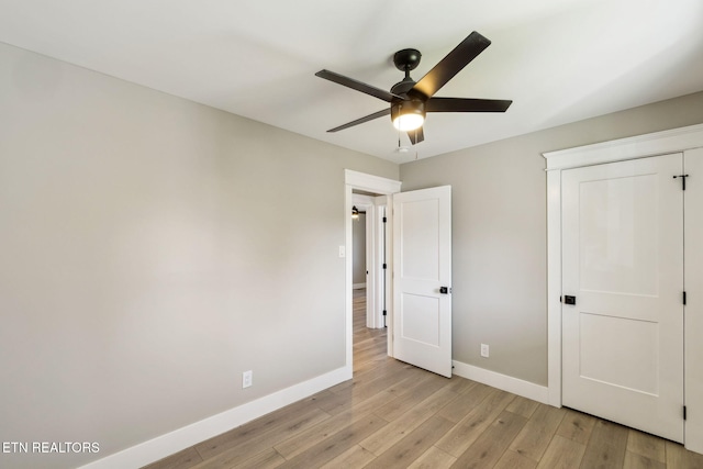 unfurnished bedroom with ceiling fan and light hardwood / wood-style flooring