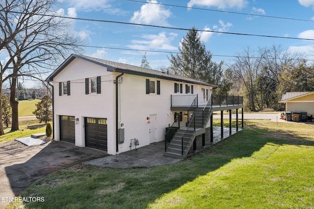 exterior space featuring a garage, a front yard, and a deck