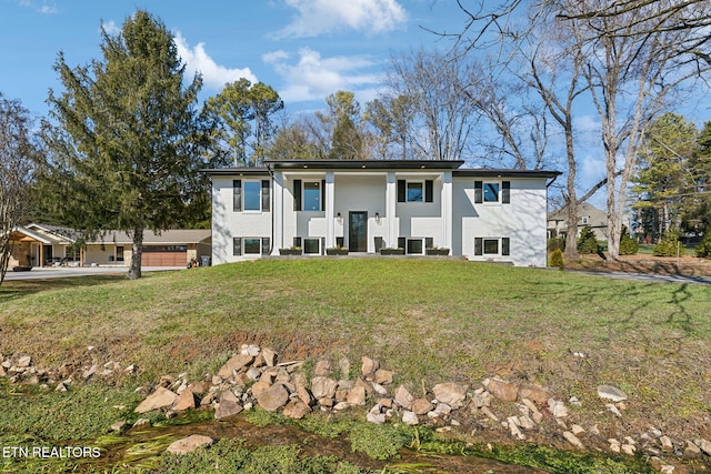 bi-level home with a front lawn