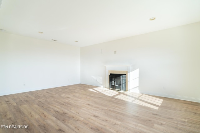 unfurnished living room featuring light wood-type flooring