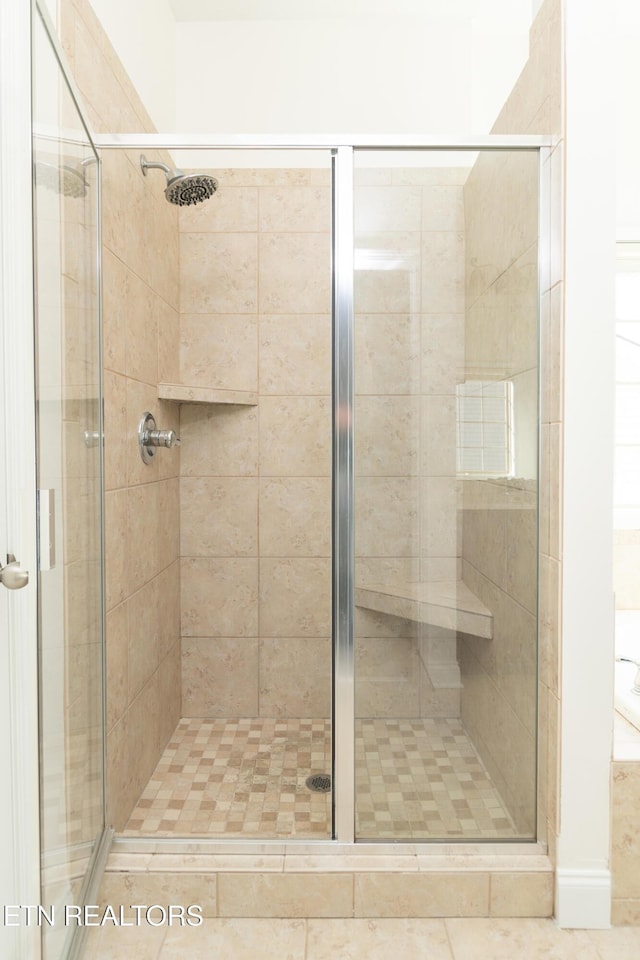 bathroom with a shower with shower door