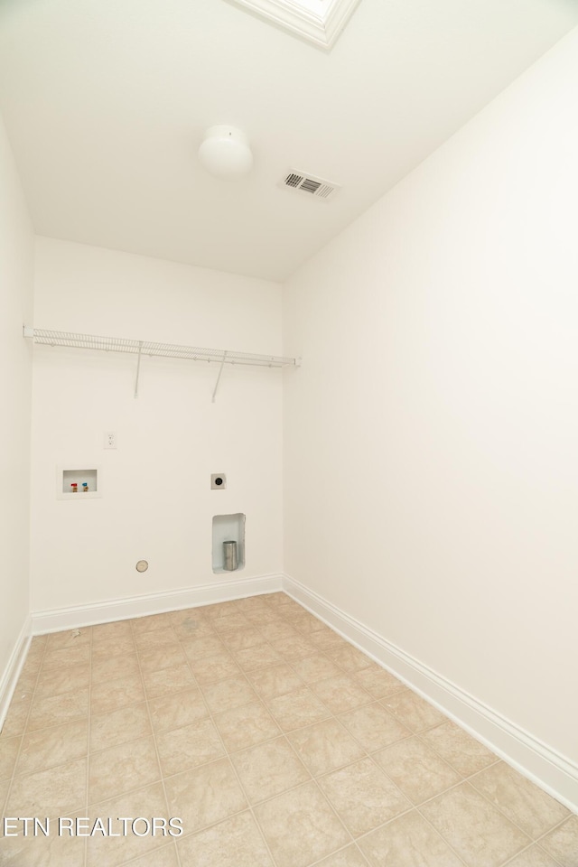 clothes washing area featuring gas dryer hookup, a skylight, hookup for a washing machine, and electric dryer hookup