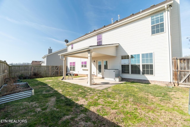 back of property with a lawn and a patio