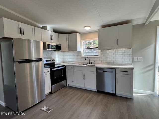 kitchen featuring white cabinetry, appliances with stainless steel finishes, and sink