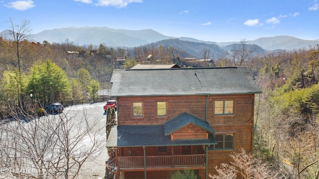 rear view of property featuring a mountain view