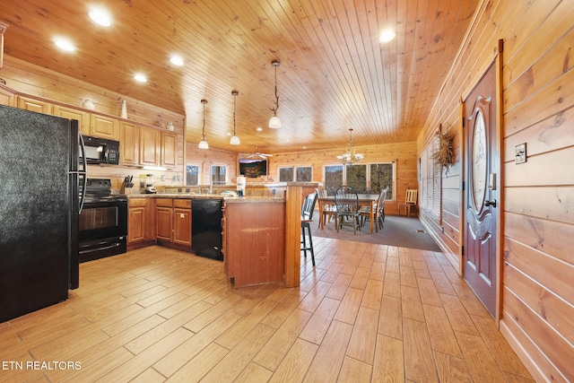 kitchen featuring pendant lighting, black appliances, a breakfast bar area, kitchen peninsula, and wooden ceiling