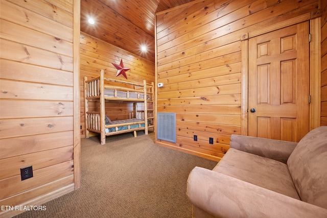 bedroom with wood ceiling, carpet floors, and wooden walls