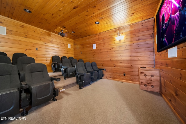 home theater with wooden ceiling, carpet flooring, and wood walls