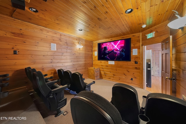 cinema room featuring carpet flooring, wooden walls, and wood ceiling