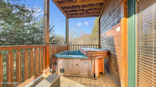 wooden deck with a hot tub