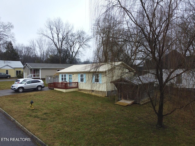 view of front of property with a wooden deck and a front yard