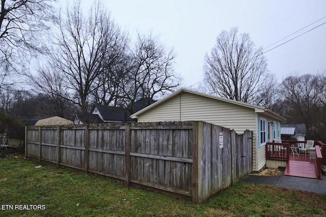 exterior space with a wooden deck and a yard