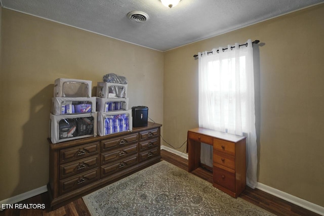 interior space with dark hardwood / wood-style floors and a textured ceiling