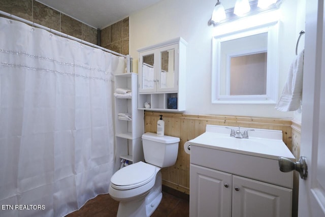 bathroom featuring walk in shower, vanity, and toilet