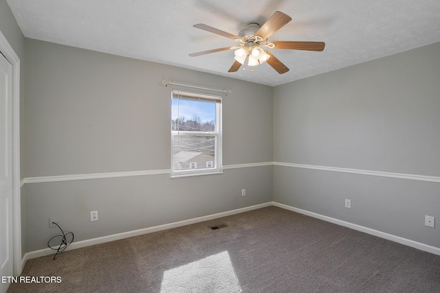 carpeted empty room featuring a textured ceiling and ceiling fan