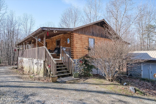 view of side of home with a porch