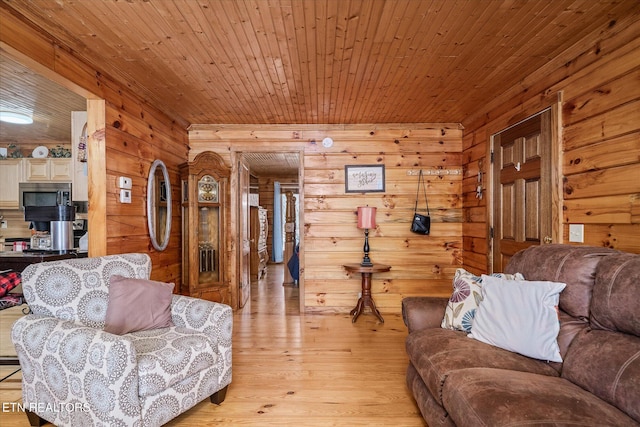 living room with wood walls, wooden ceiling, and light hardwood / wood-style flooring