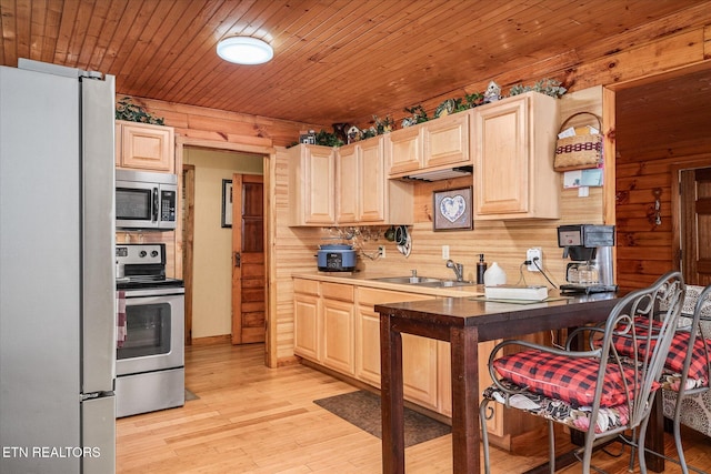 kitchen featuring appliances with stainless steel finishes, sink, light hardwood / wood-style floors, light brown cabinets, and wooden ceiling