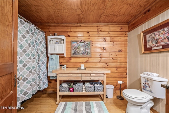 bathroom featuring wood ceiling, toilet, and hardwood / wood-style floors