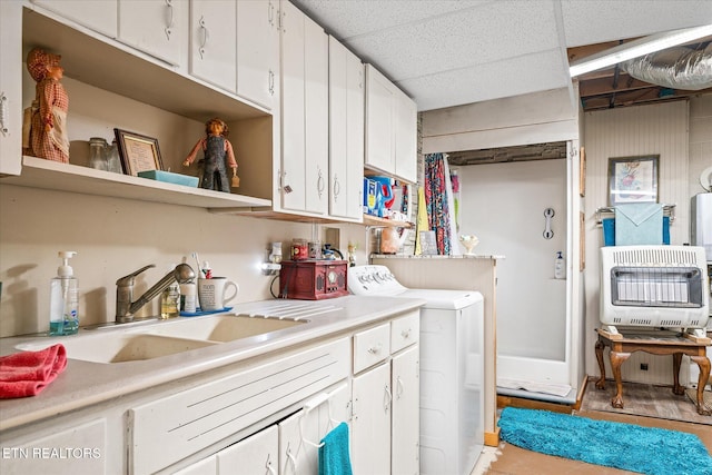 washroom featuring washer / clothes dryer, sink, and heating unit