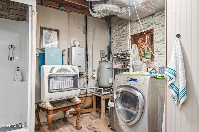 clothes washing area featuring heating unit and washer / dryer