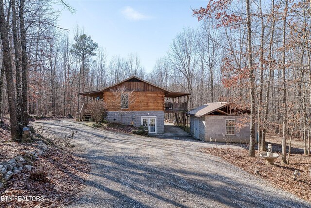 view of side of property with a wooden deck and french doors