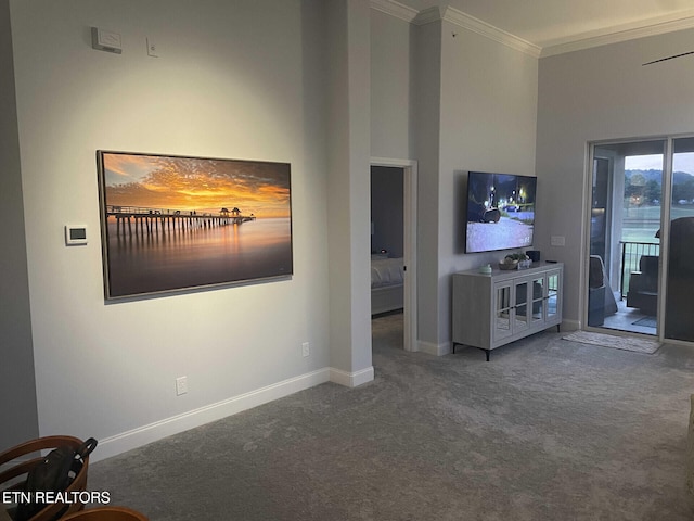 unfurnished living room with a high ceiling, crown molding, and carpet flooring