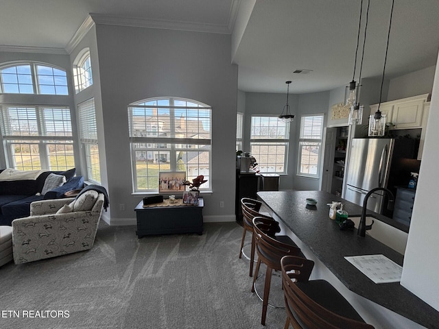 dining room with crown molding and dark carpet