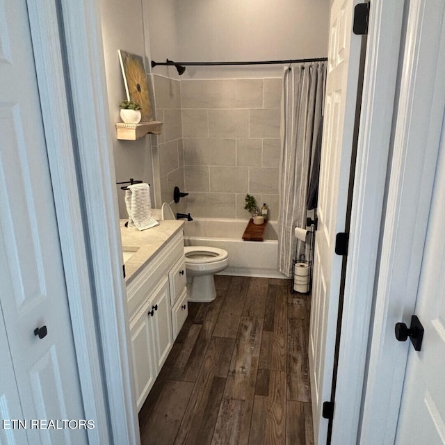 full bathroom with vanity, hardwood / wood-style floors, toilet, and shower / tub combo with curtain