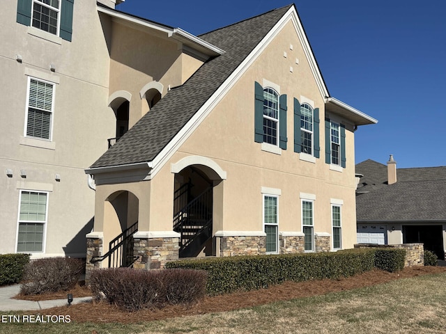 545 Rarity Bay Pkwy Apt 207, Vonore, TN 37885 - view of front of home featuring stone siding, stucco siding, and roof with shingles