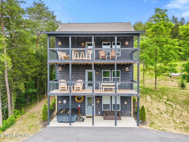 view of front of house with a patio and a balcony