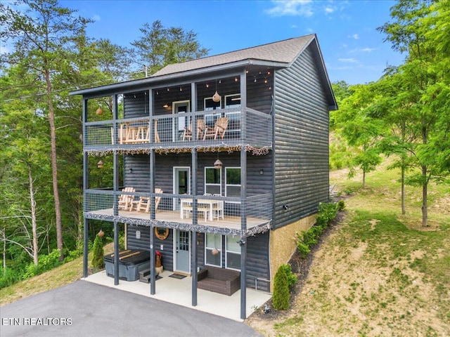 coastal inspired home with a patio and a balcony