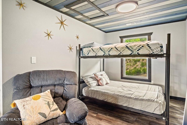 bedroom with vaulted ceiling and hardwood / wood-style floors