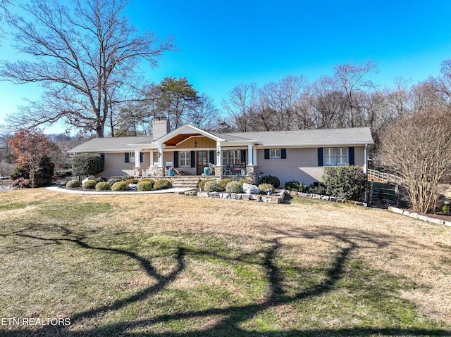 view of front of home with a front yard and covered porch