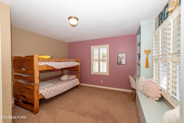 bedroom with carpet flooring and a textured ceiling