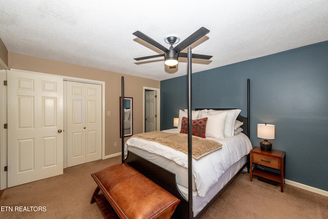 carpeted bedroom with a textured ceiling and ceiling fan