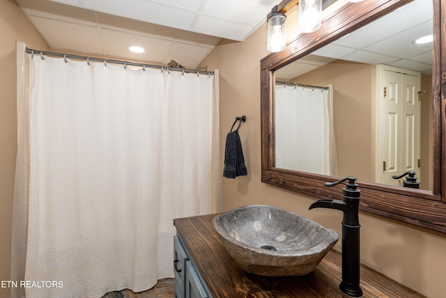 bathroom with vanity and a drop ceiling