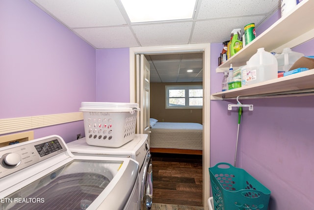 washroom featuring dark hardwood / wood-style flooring and washer and clothes dryer