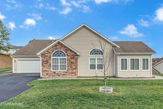 ranch-style house with aphalt driveway, roof with shingles, a garage, stone siding, and a front lawn