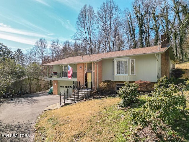 view of front of home with a garage and a front yard